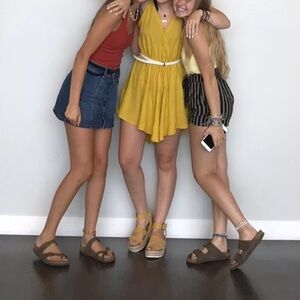 Yellow romper with tasseled straps